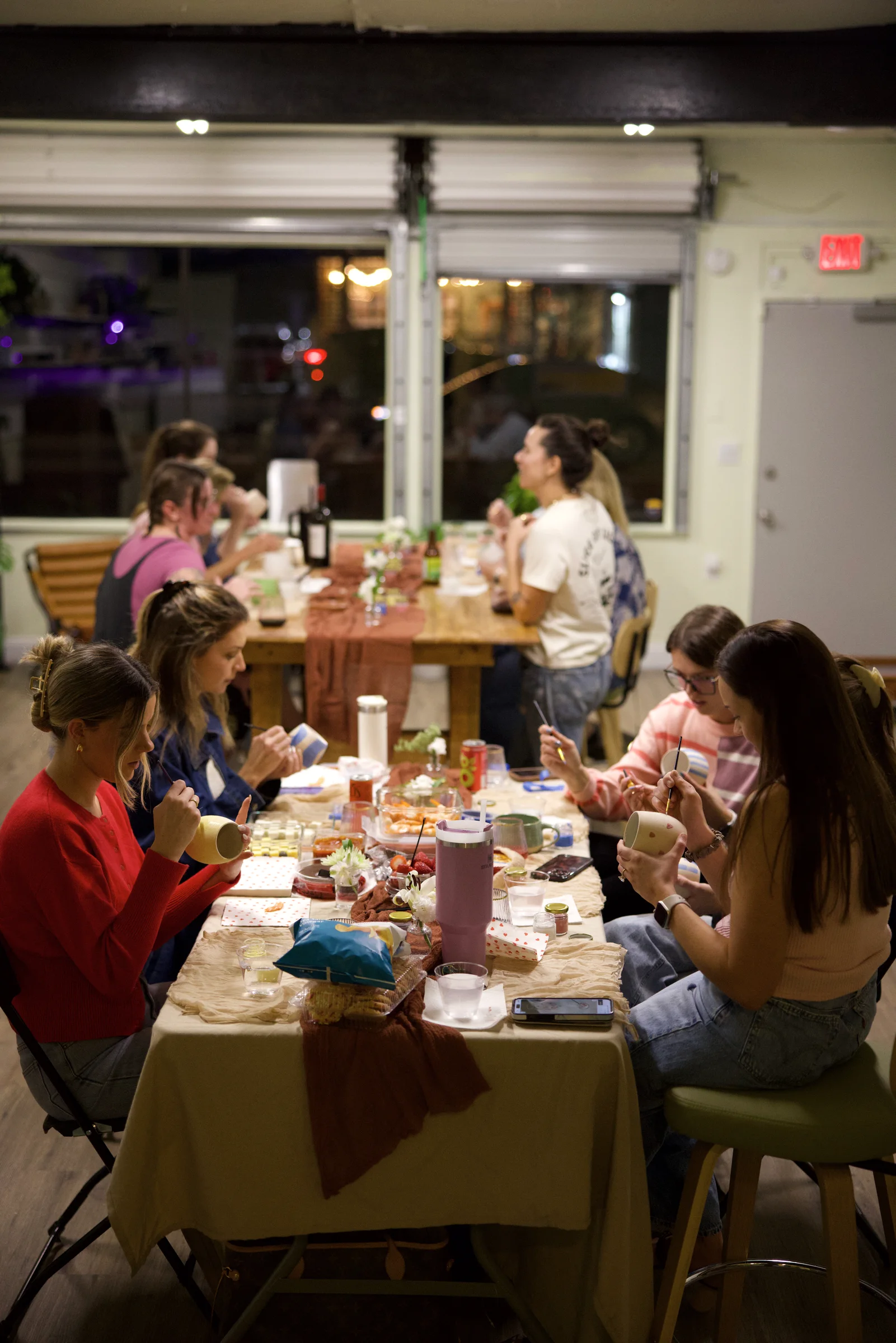 Group of friends painting ceramics at a private party at Floridian Ceramics in Tampa