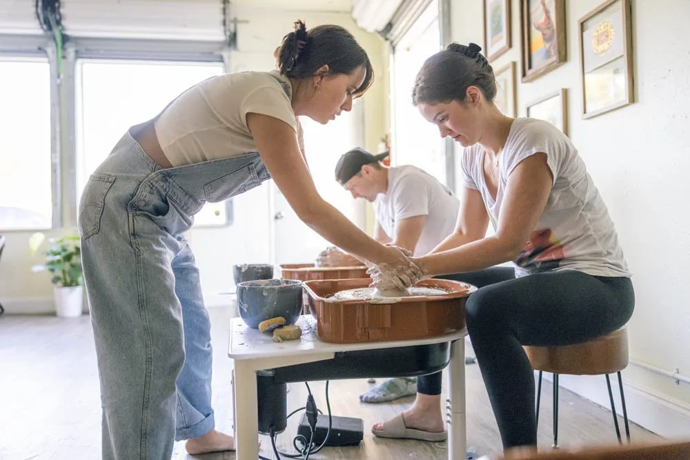 Hands on a pottery wheel during an intro class at Floridian Ceramics Tampa