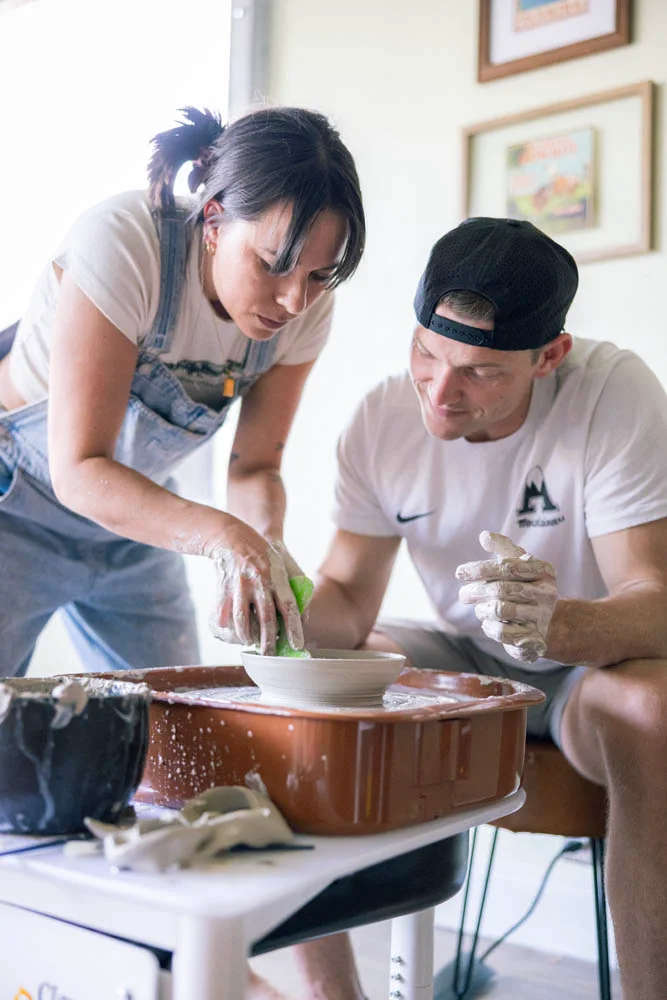 Hands on a pottery wheel during an intro class at Floridian Ceramics Tampa