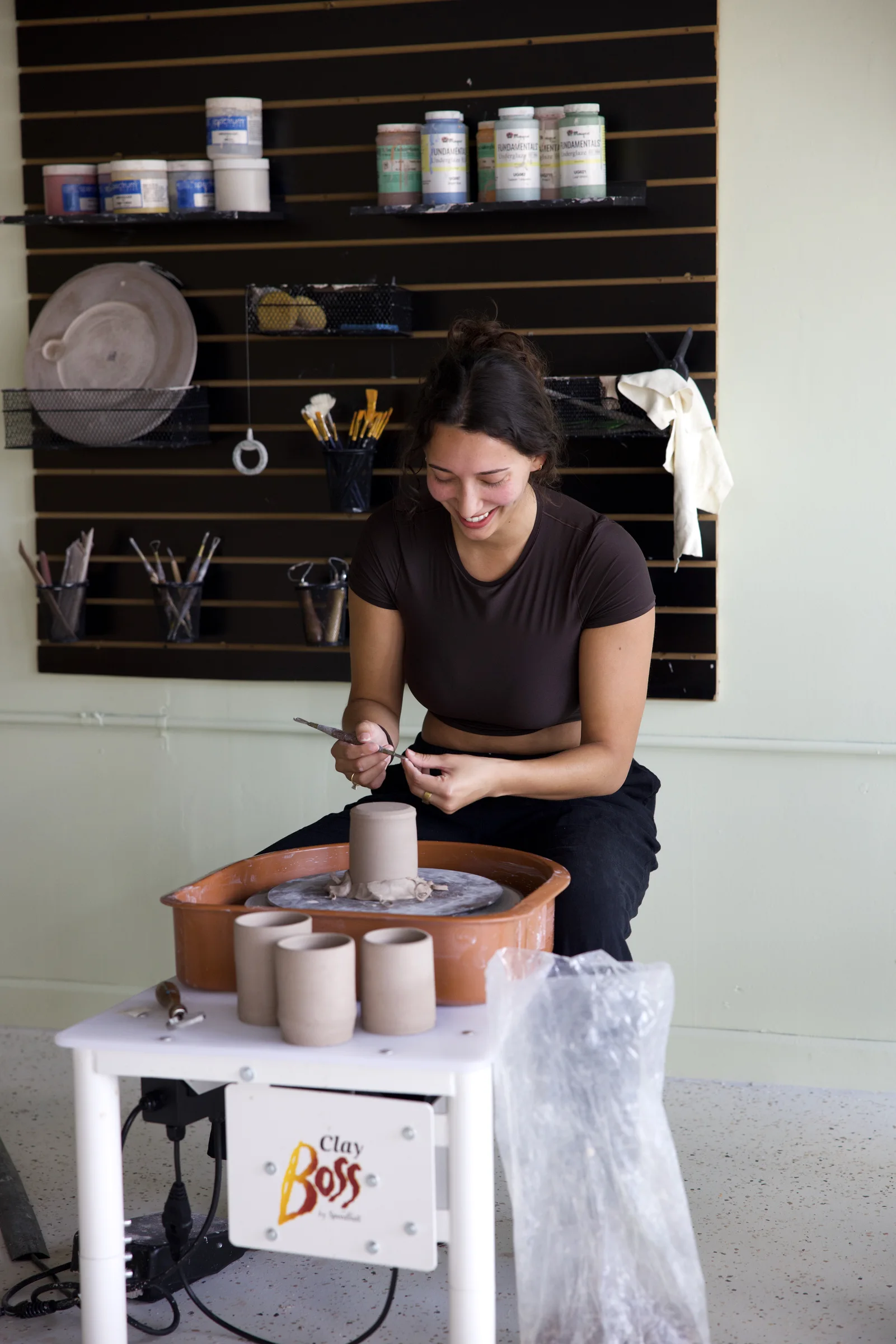 Friends laughing during a small pottery class at Floridian Ceramics in Seminole Heights Tampa